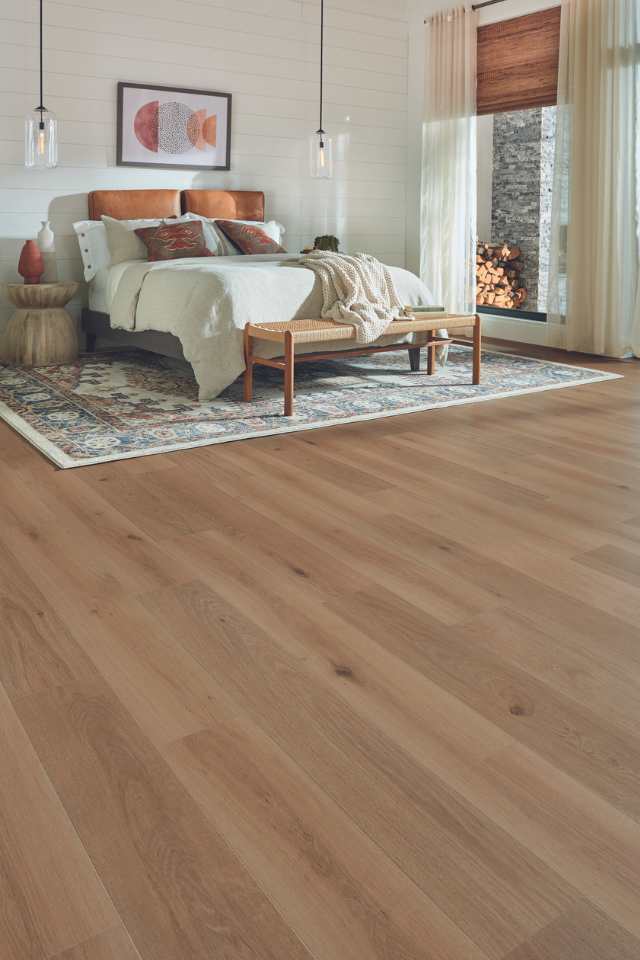 wood look laminate in earth toned bedroom with white shiplap walls 